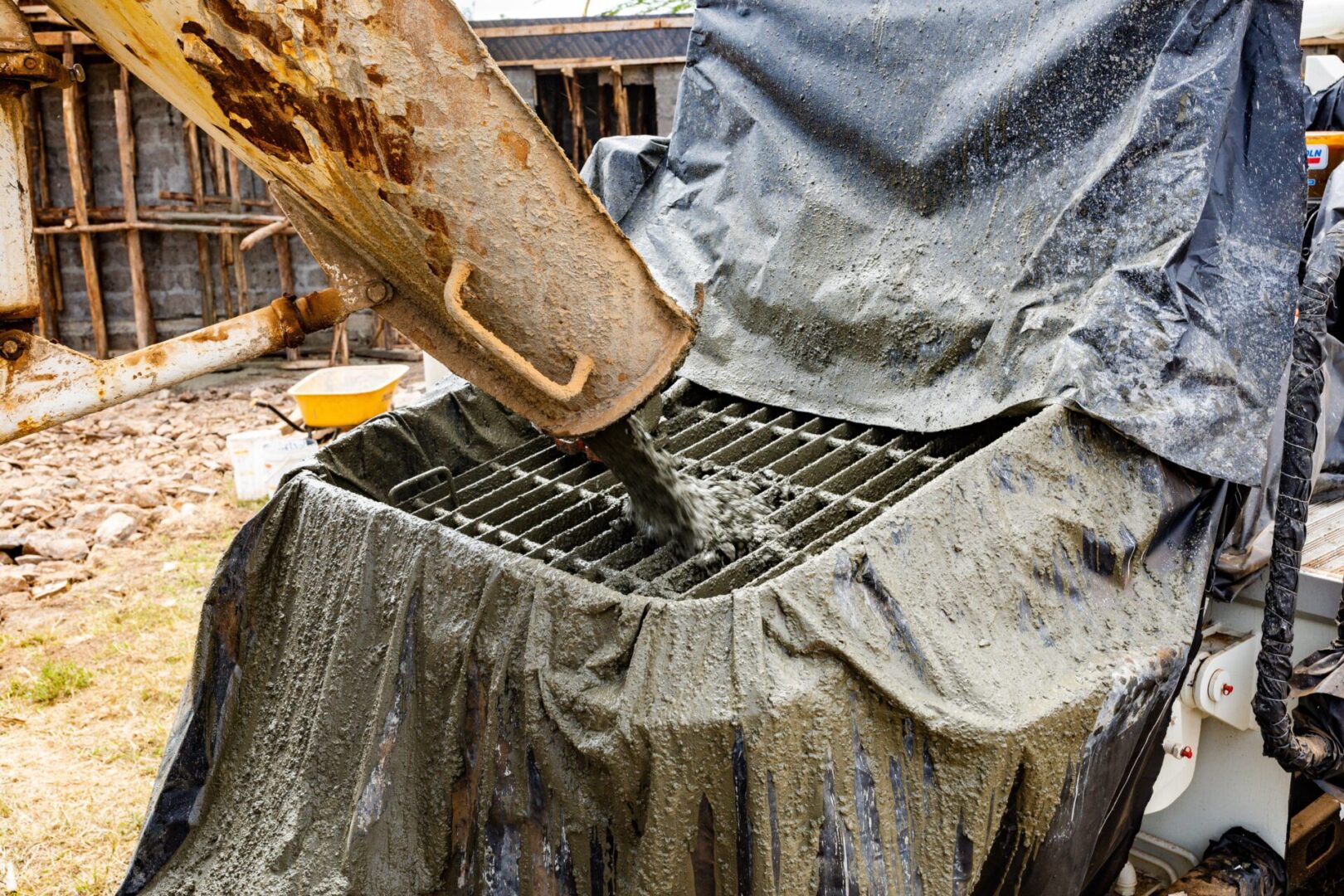 A person is pouring concrete into the grill.