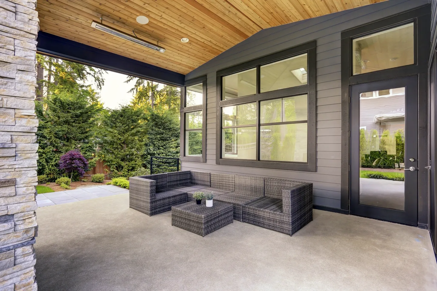 A patio with furniture and a table outside.