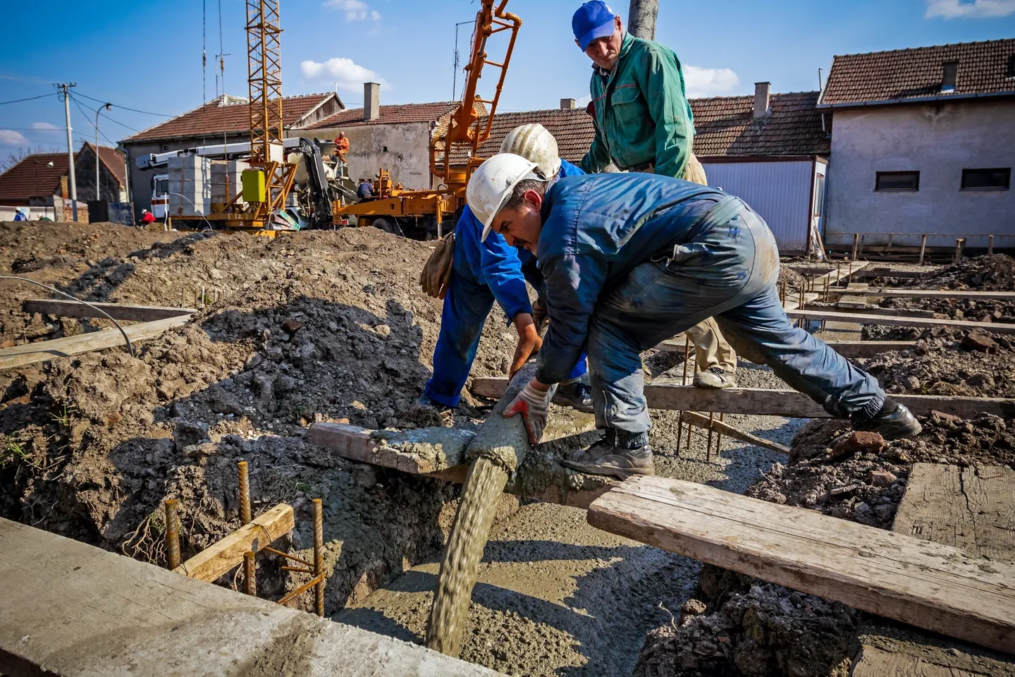 A group of construction workers working on the ground.