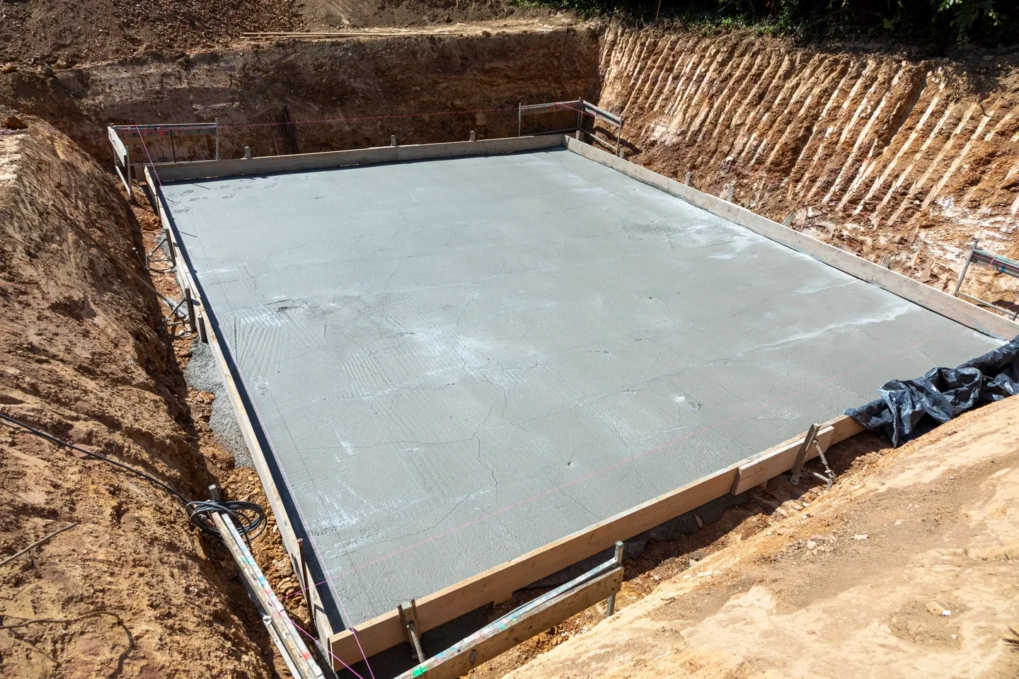 A concrete slab is being poured for the foundation of a house.