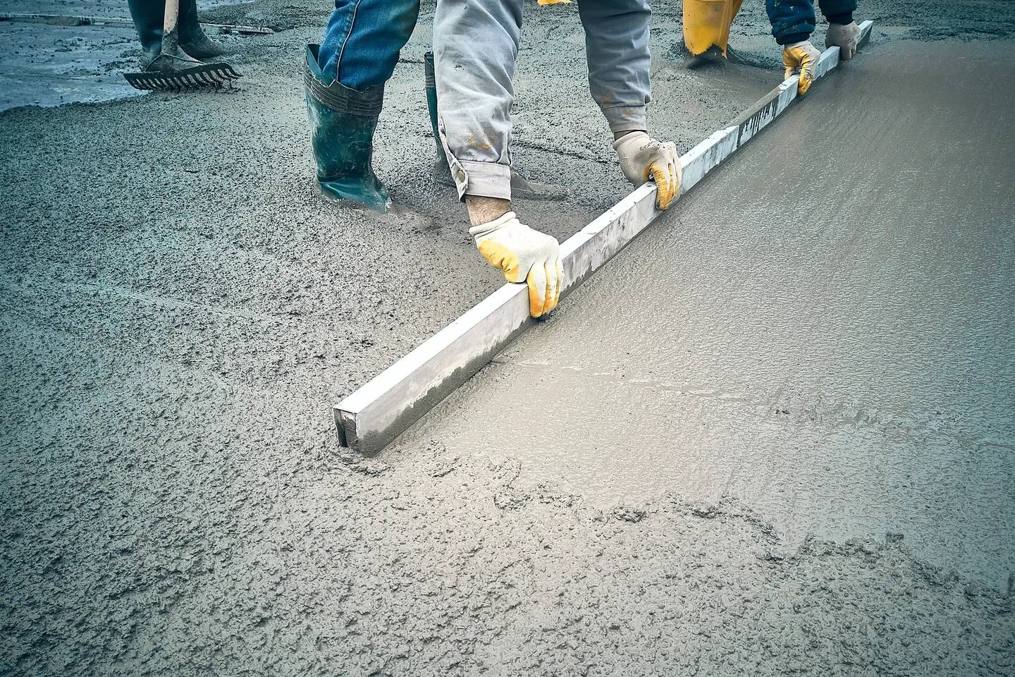 A group of people standing on top of cement.